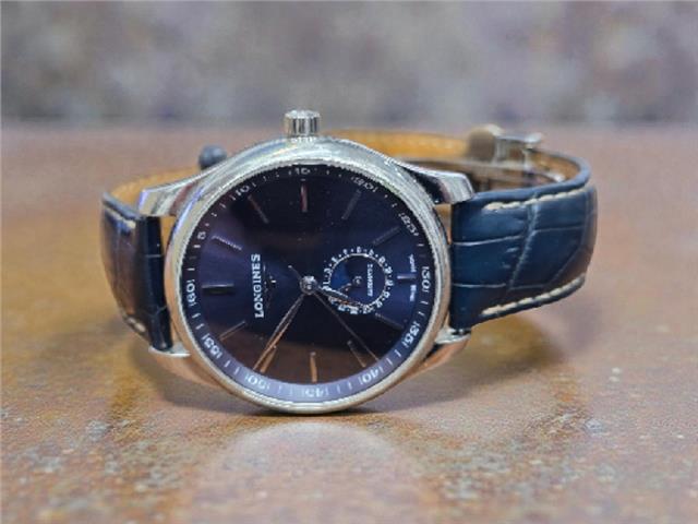 Longines Master Collection watch with boxed papers, featuring a classic design and stainless steel bracelet.