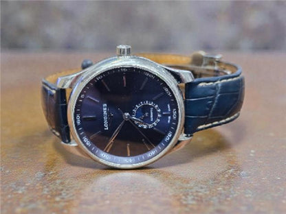 Longines Master Collection watch with boxed papers, showcasing its elegant dial and stainless steel bracelet.