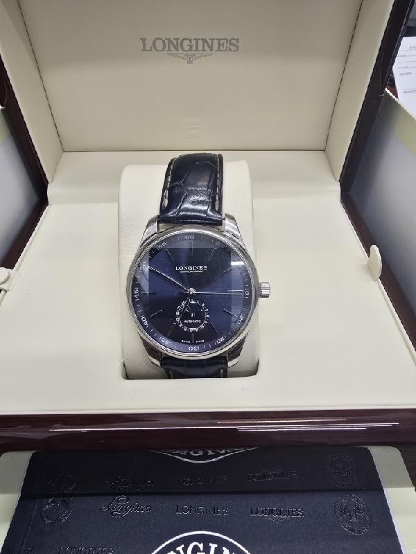Longines Master Collection watch with boxed papers, featuring a stainless steel case, white dial, and classic design.