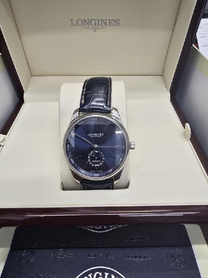 Longines Master Collection watch with boxed papers, featuring a stainless steel case, white dial, and classic design.