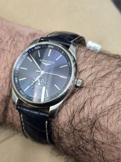 Longines Master Collection watch with boxed papers, featuring a classic design and stainless steel case.