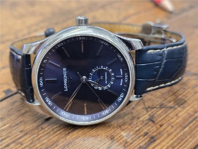 Longines Master Collection watch with boxed papers, featuring a sleek silver dial and stainless steel bracelet.