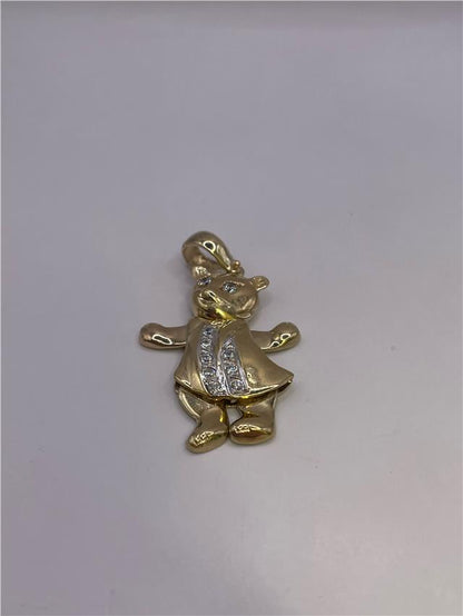 9ct gold pendant weighing 8.9g, featuring a smooth polished surface and elegant design, crafted in gold.