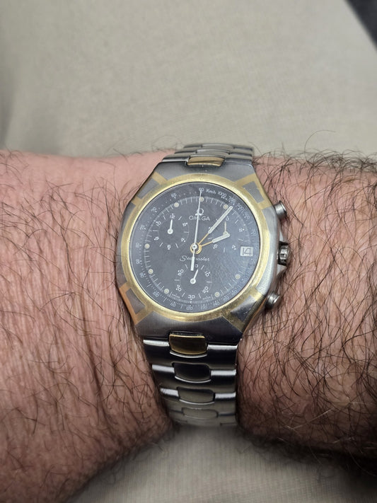 Omega Seamaster Polaris Chronograph watch with boxed and card, featuring a stainless steel case and black dial.