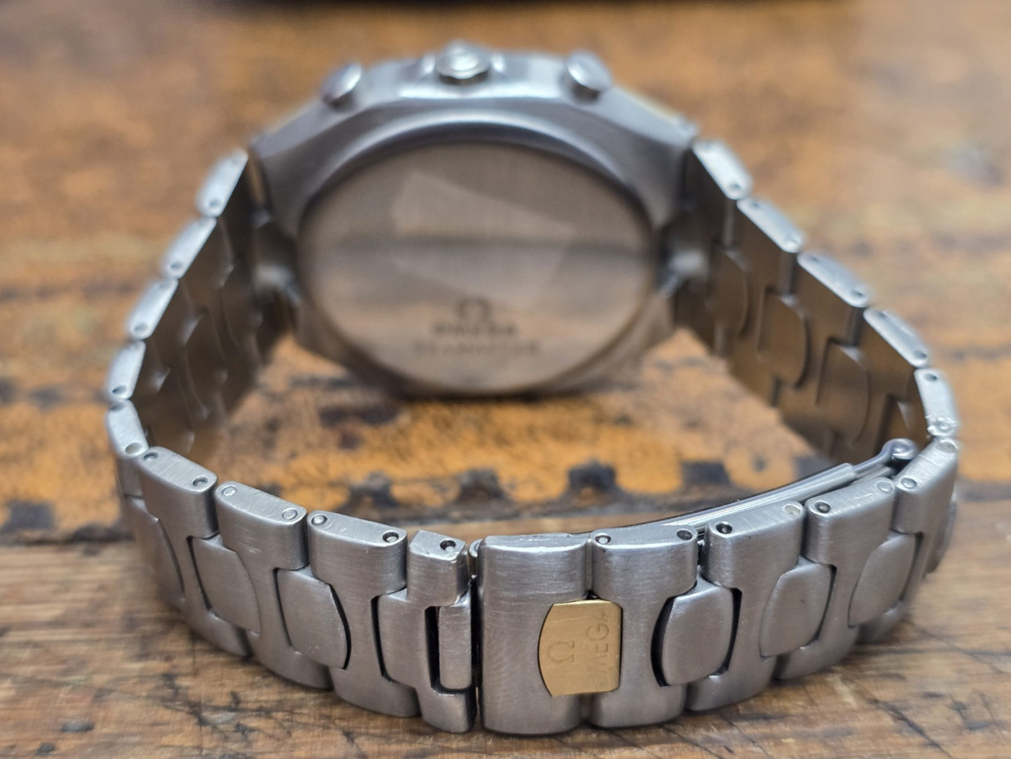 Omega Seamaster Polaris Chronograph watch with box and card, featuring a stainless steel case and black dial.