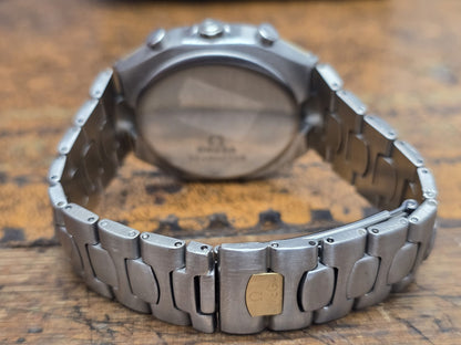 Omega Seamaster Polaris Chronograph watch with box and card, featuring a stainless steel case and black dial.