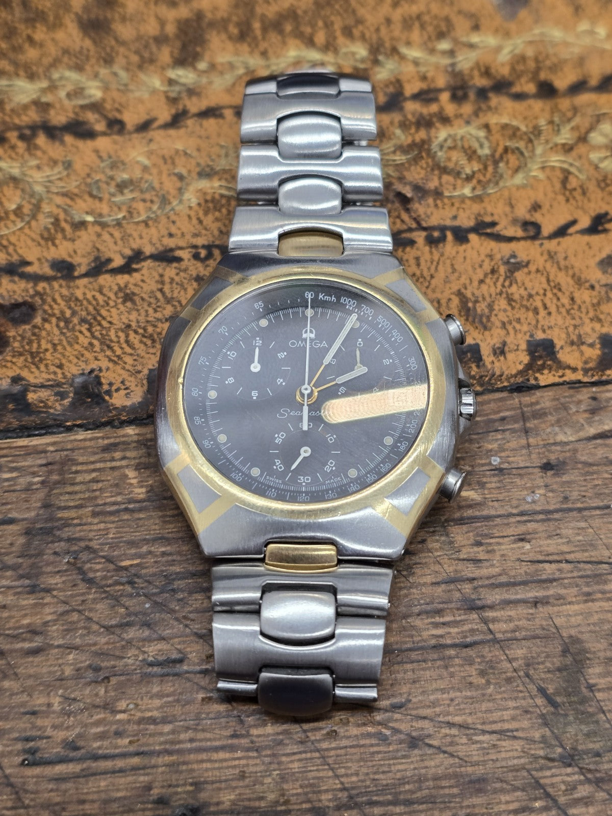 Omega Seamaster Polaris Chronograph watch with box and card, featuring a stainless steel case and black dial.