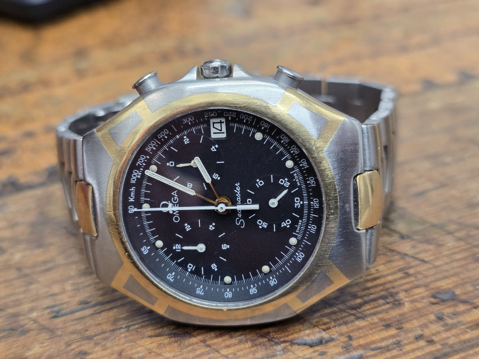 Omega Seamaster Polaris Chronograph watch with box and card, showcasing the stainless steel case and detailed dial.