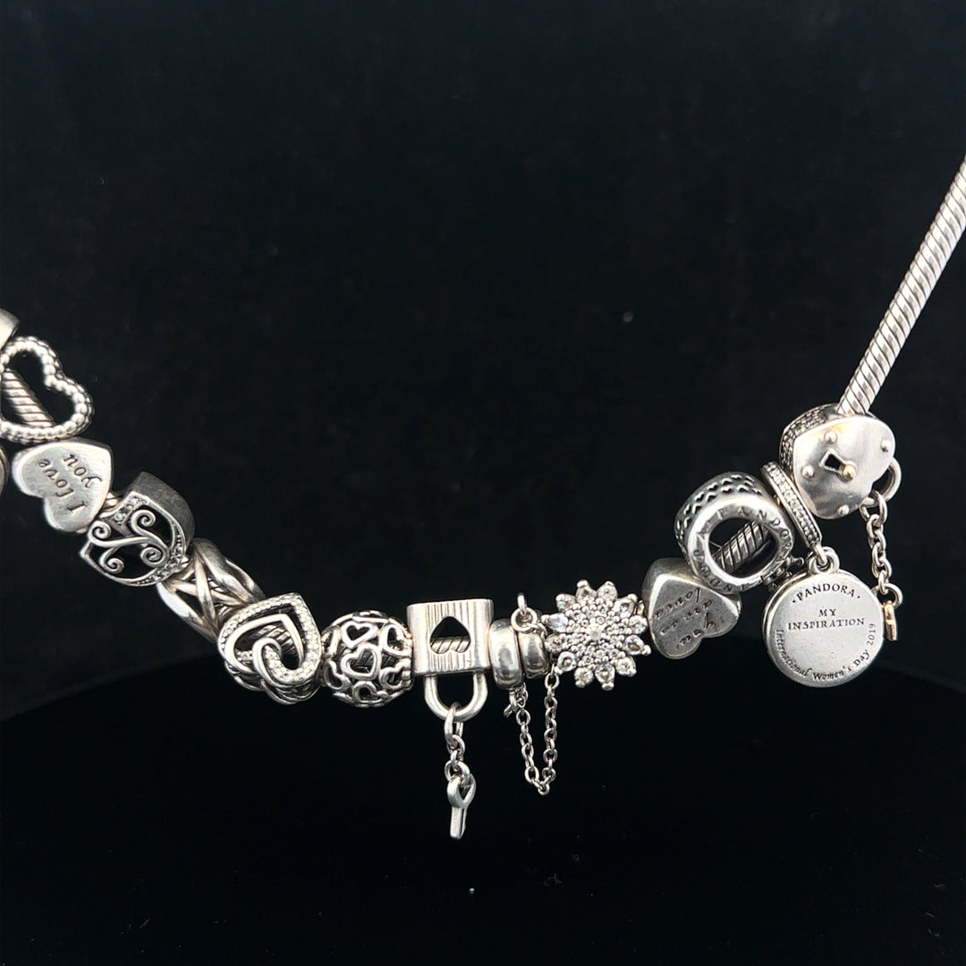 Pandora charm necklace, 20 inches, silver tone with decorative charms, elegant jewelry piece on a white background.