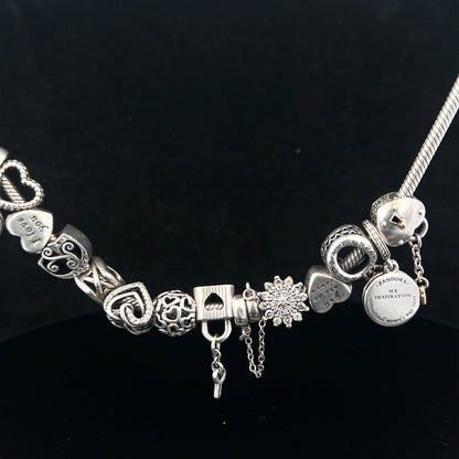 Pandora charm necklace, 20 inches, silver tone with decorative charms, elegant jewelry piece on a white background.