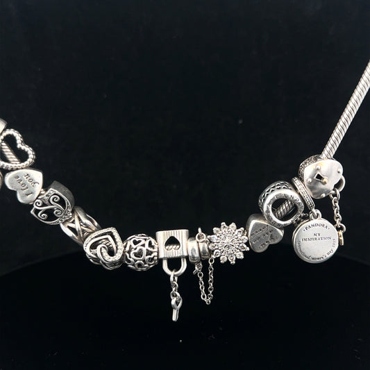 Pandora charm necklace, 20 inches, silver tone with decorative charms, elegant jewelry piece on a white background.