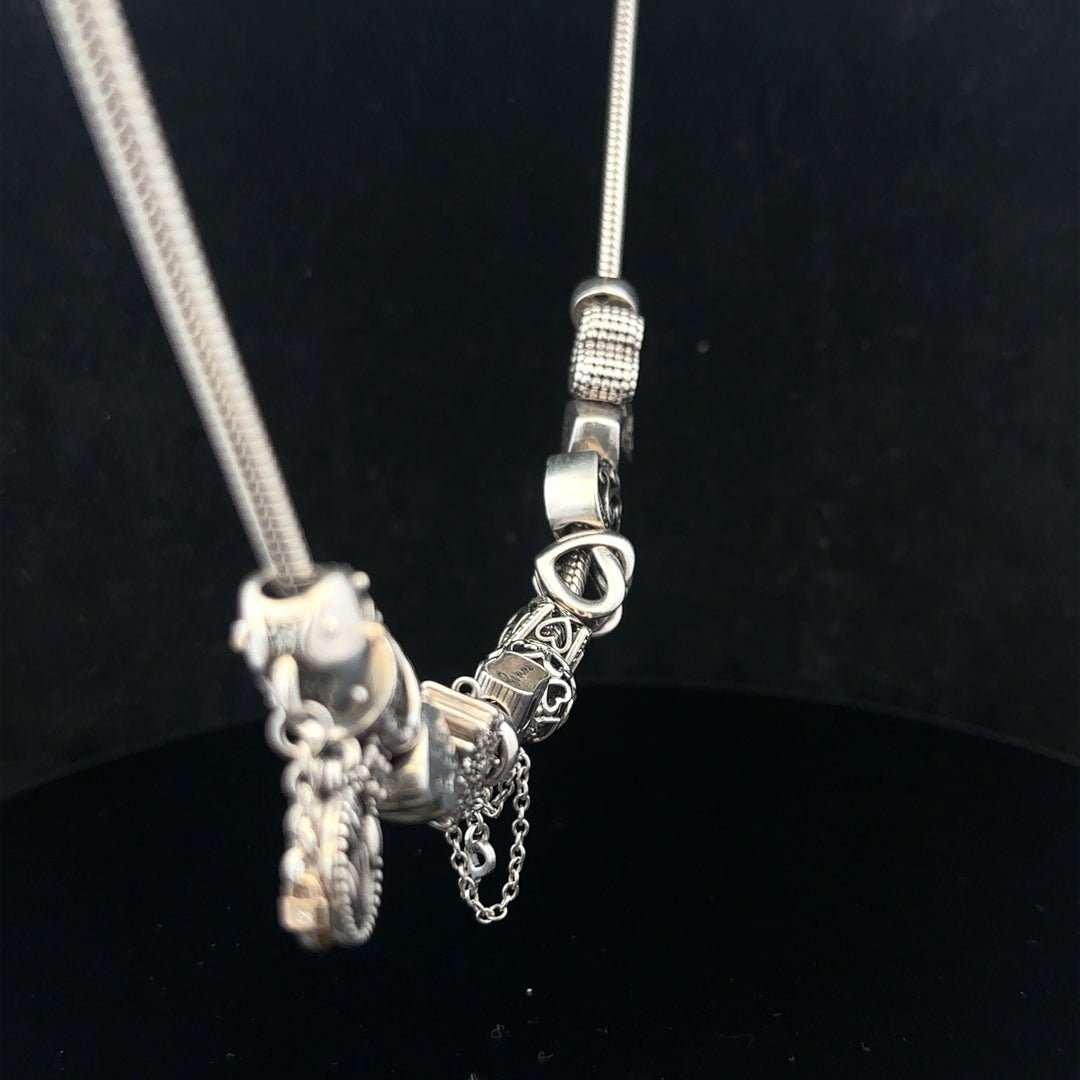 Pandora 20-inch charm necklace with silver chain and decorative charms, stylish jewelry accessory for women.