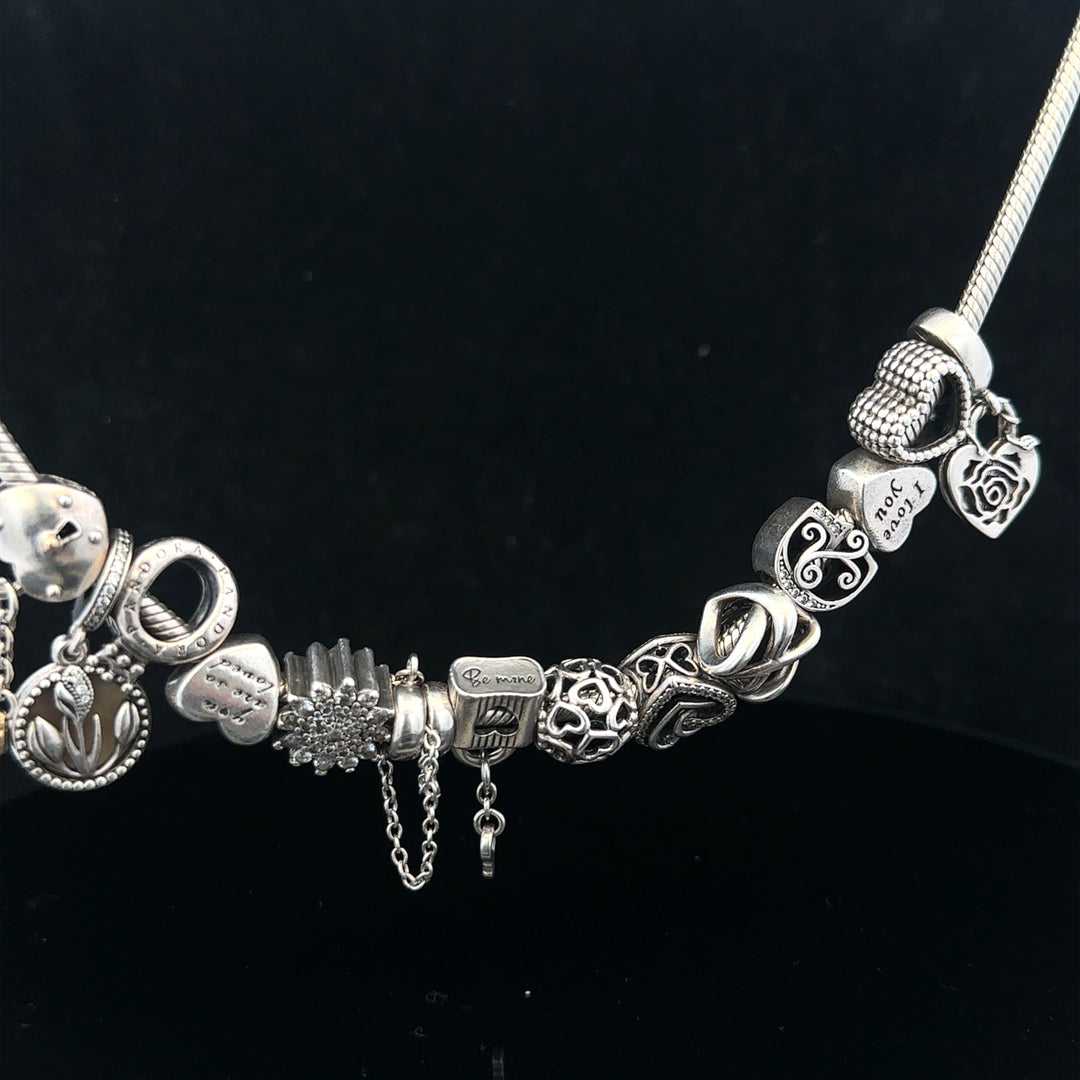 PANDORA 20-inch charm necklace featuring a silver chain with decorative charms, styled on a neutral background.