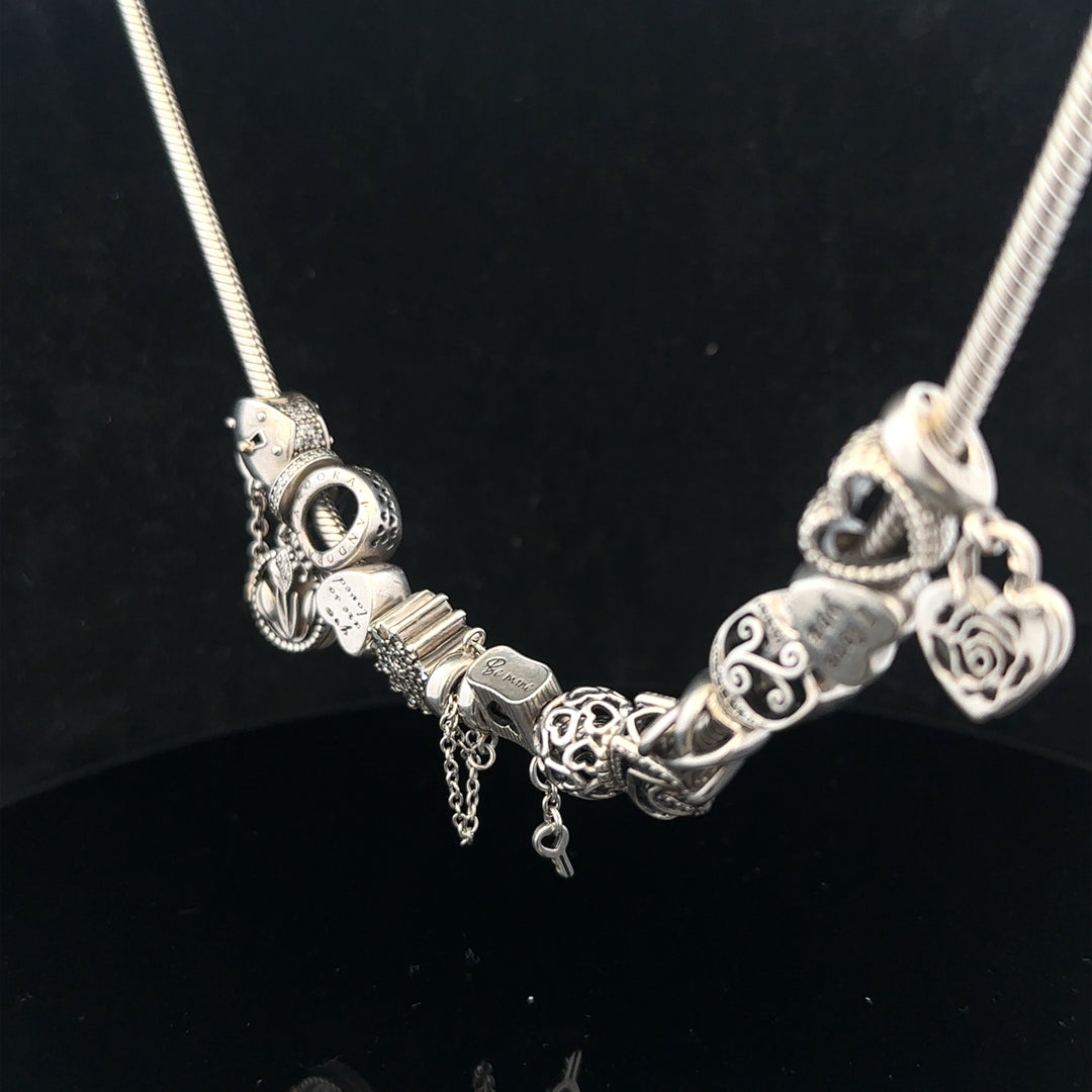 Pandora 20-inch charm necklace with silver chain and decorative charms, stylish jewelry accessory.