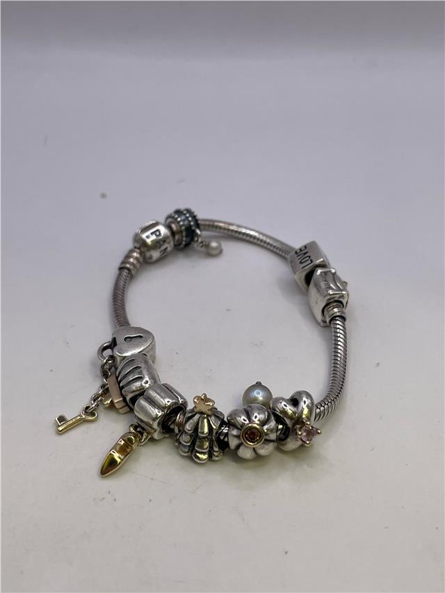 Silver Pandora bracelet featuring a sleek design, weighing 42.3 grams, with a shiny finish and intricate details.