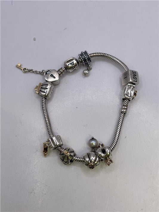 Silver Pandora bracelet featuring intricate chain links and clasp, showcasing elegant jewelry craftsmanship.