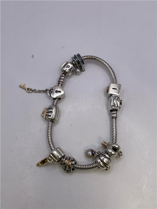 Silver Pandora bracelet with intricate design, weighing 42.3 grams, featuring detailed craftsmanship and a polished finish.