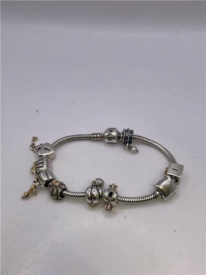 Silver Pandora bracelet with intricate design, weighing 42.3 grams, featuring the SH24648B style, detailed close-up shot.