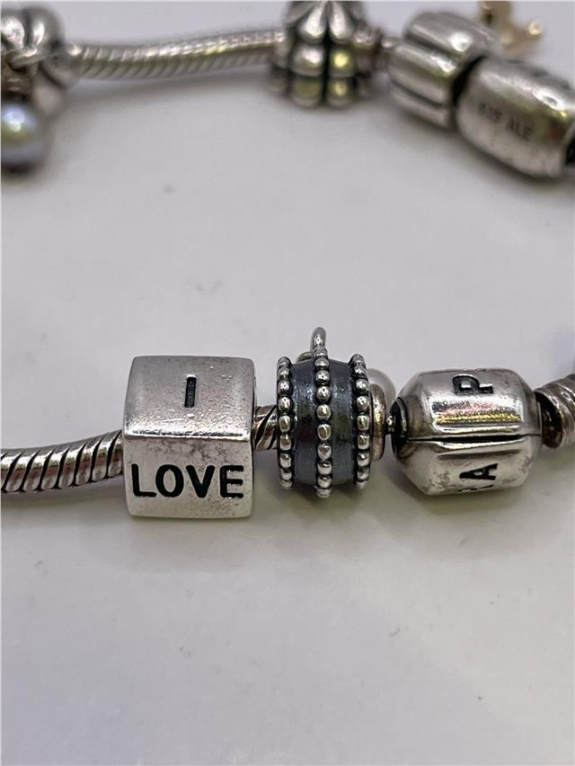 Silver Pandora bracelet with intricate chain design, weighing 42.3 grams, featuring detailed craftsmanship and a polished finish.