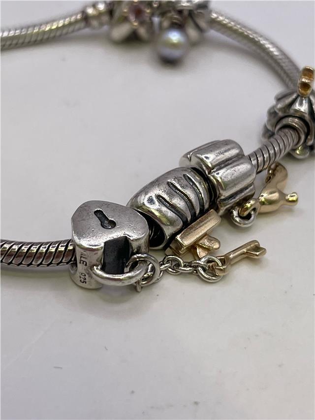 Silver Pandora bracelet with intricate design, weighing 42.3 grams, featuring a sleek and stylish jewelry piece.