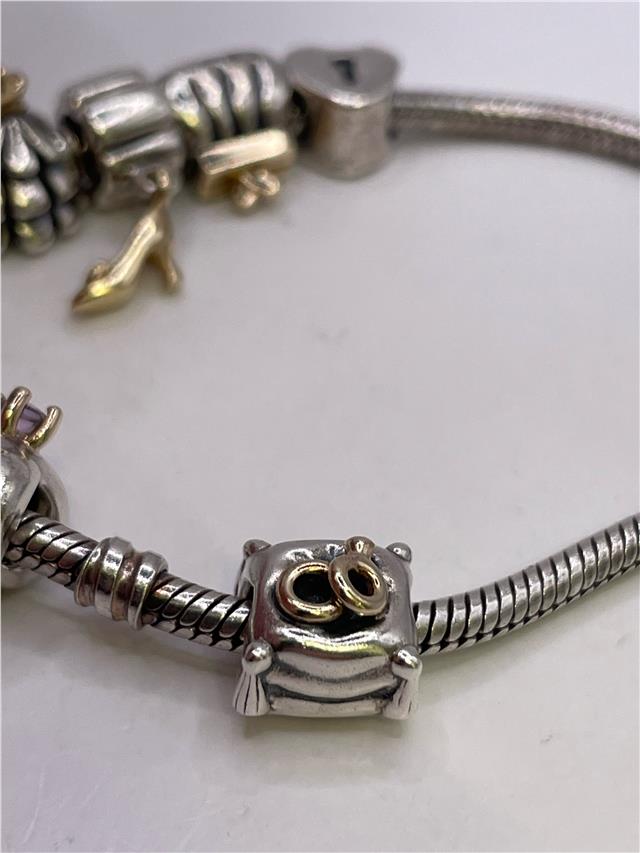 Silver Pandora bracelet with intricate design, weighing 42.3 grams, featuring a sleek and elegant style.