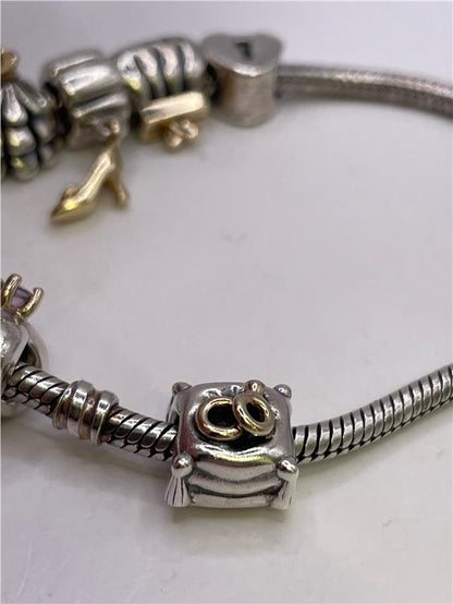 Silver Pandora bracelet with intricate design, weighing 42.3 grams, featuring a sleek and elegant style.