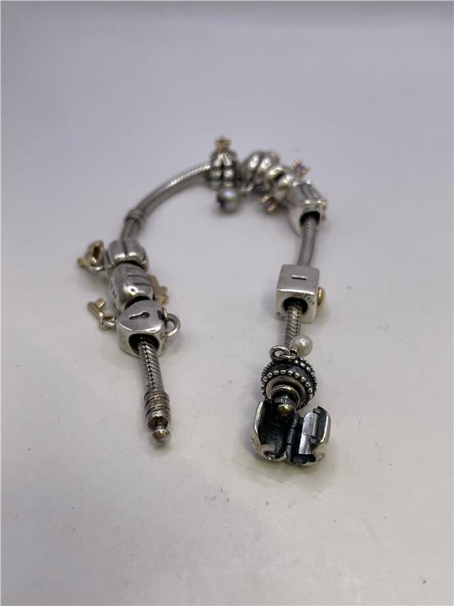 Silver Pandora bracelet with intricate link design, weighing 42.3 grams, featuring timeless craftsmanship and detailed metalwork.