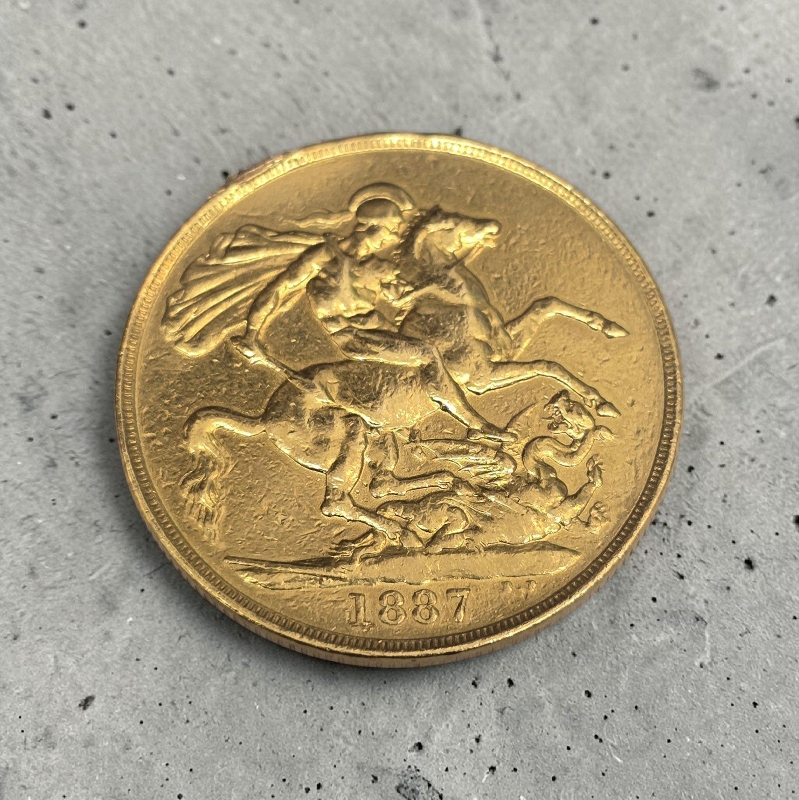 1887 Double Sovereign coin by Reeves and Sons, showing detailed side and classic design with intricate engravings.