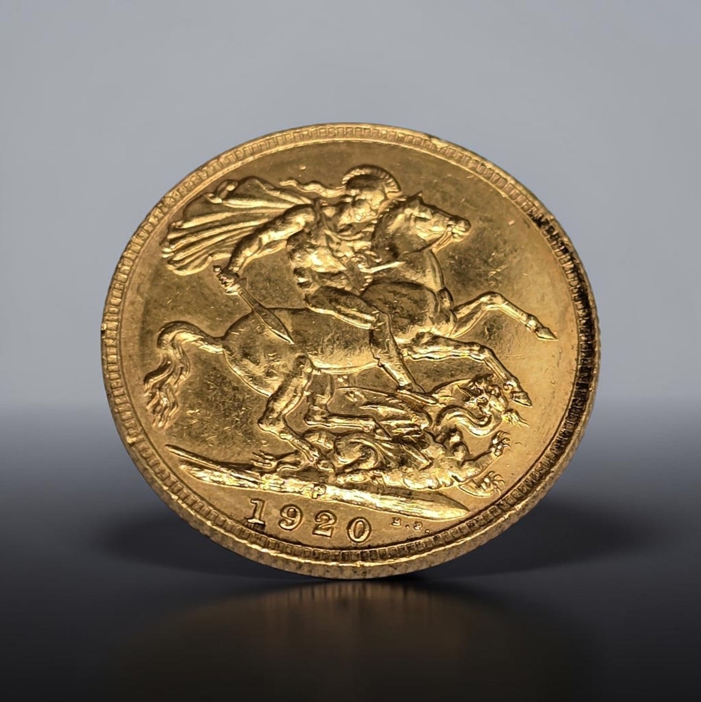 1920 full sovereign coin by Reeves and Sons, 8g gold coin with detailed sovereign design, historical currency from the United Kingdom.