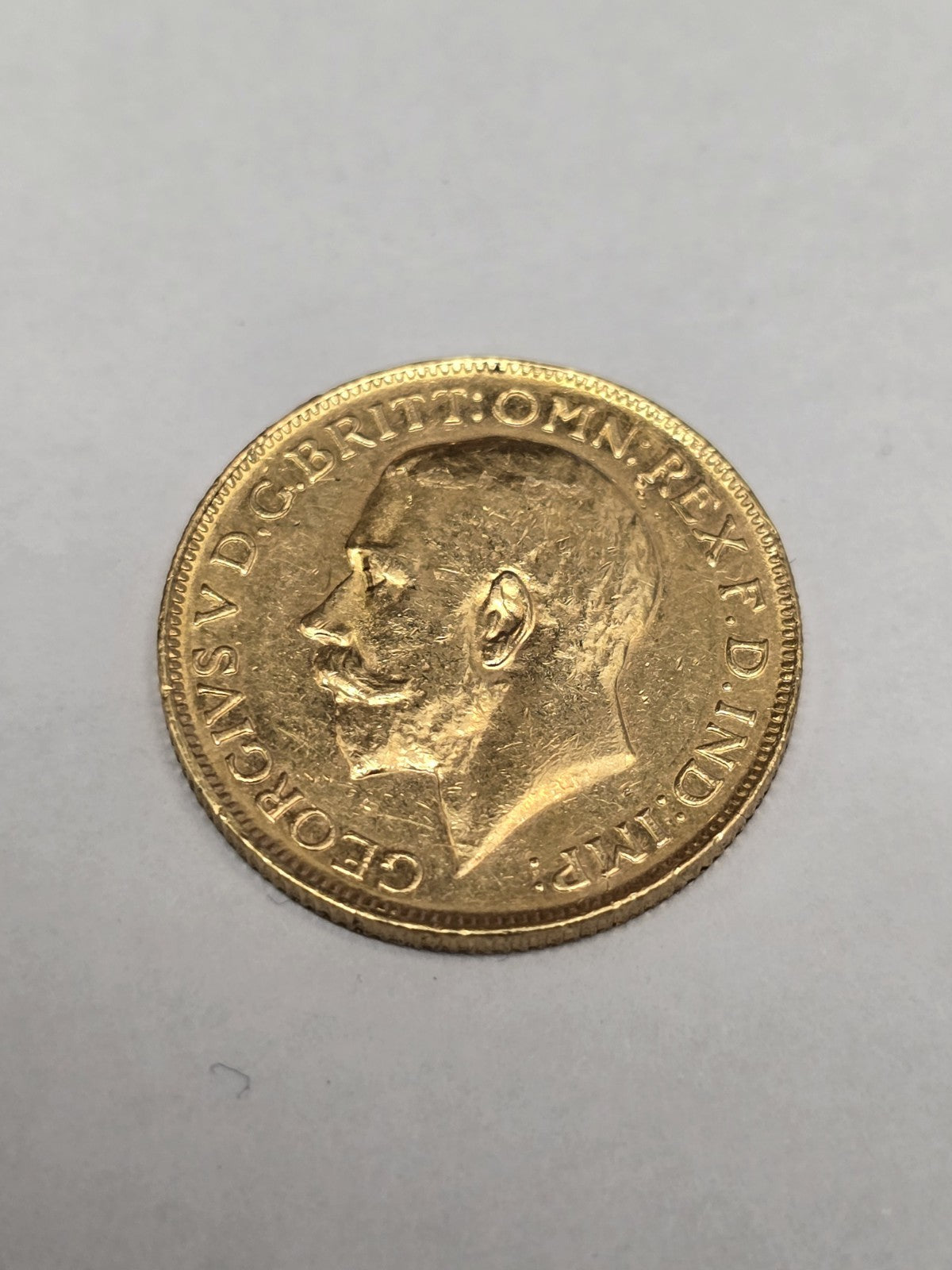1920 Reeves and Sons full sovereign coin, 8g gold, detailed design and historical imagery, vintage British currency.