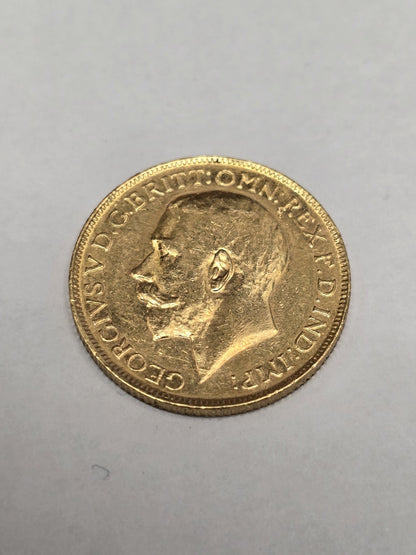 1920 Reeves and Sons full sovereign coin, 8g gold, detailed design and historical imagery, vintage British currency.