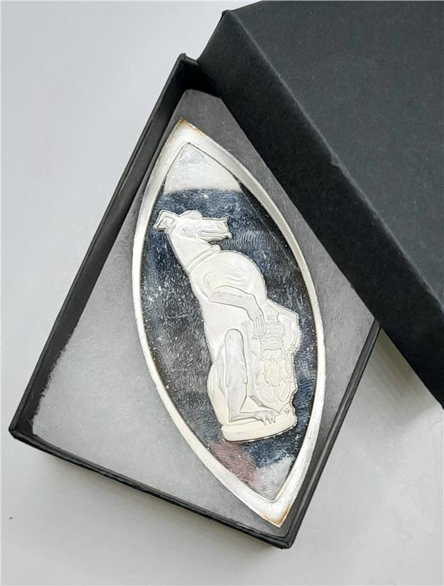 Silver ingot featuring The Queen's Beasts design by Reeves and Sons, showcasing a detailed embossed motif on a shiny silver surface.