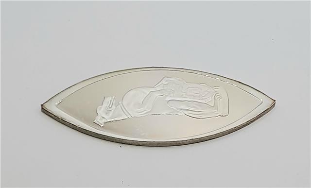 Reeves and Sons Queen's Beasts silver ingot with detailed engravings and brand logo on shiny surface.