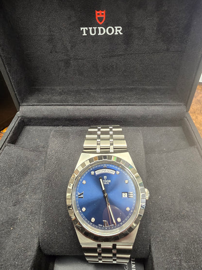 Reeves and Sons Tutor Royal Day Date Diamond Watch Model 28600 with diamond accents, classic design, and stainless steel band.