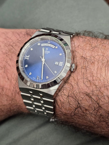 Reeves and Sons Tutor Royal Day Date Diamond Watch Model 28600, stainless steel case, white dial with date display and diamond accents.
