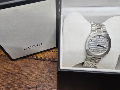 Reeves and Sons ladies Gucci watch box with accompanying paper, featuring elegant design and branding details.