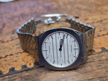 Reeves and Sons Ladies Gucci watch box with accompanying paper, elegant packaging for a luxury wristwatch.