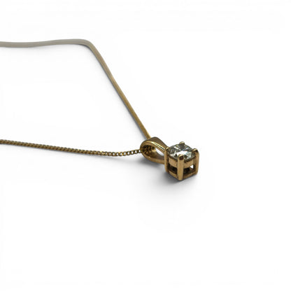 9ct yellow gold diamond pendant with 0.25 carats, displayed on a matching chain, by Reeves and Sons.