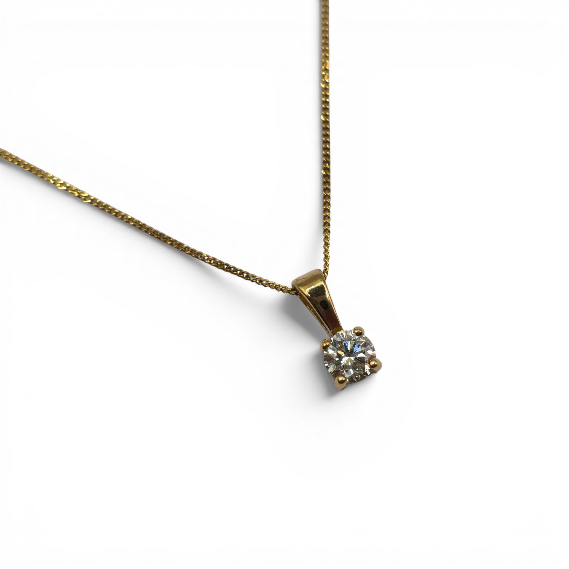 Reeves and Sons 9ct yellow gold pendant with 0.25ct diamond, paired with a matching 9ct gold chain, displayed on a neutral background.