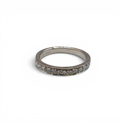 18ct white gold half eternity diamond ring by Reeves and Sons, showcasing sparkling diamonds around the band.