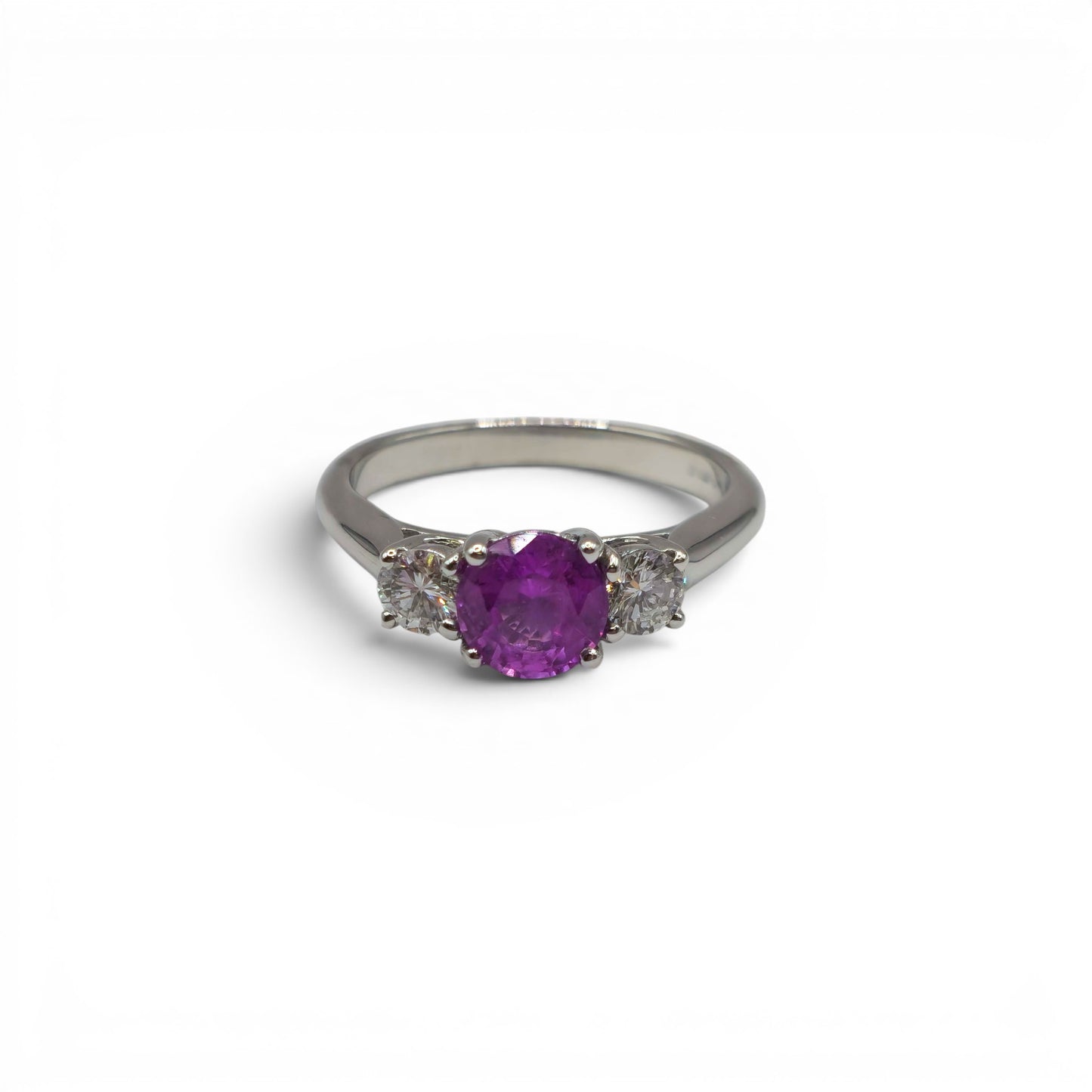 18ct white gold pink sapphire and diamond ring by Reeves and Sons, showcasing a pink sapphire center with diamond accents.