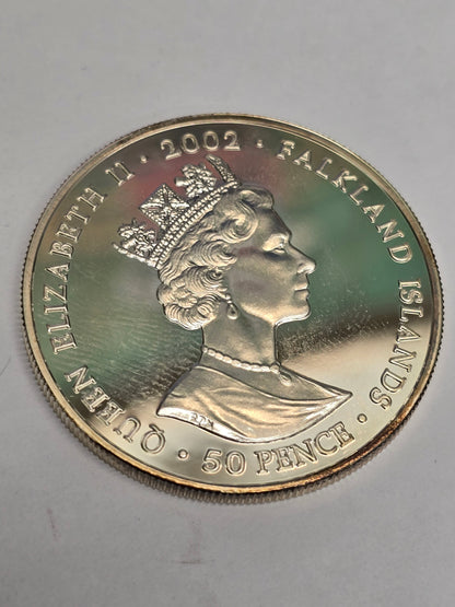 Silver 50 pence golden jubilee coin from 2002 by Reeves and Sons, showing detailed coin design on a plain background.