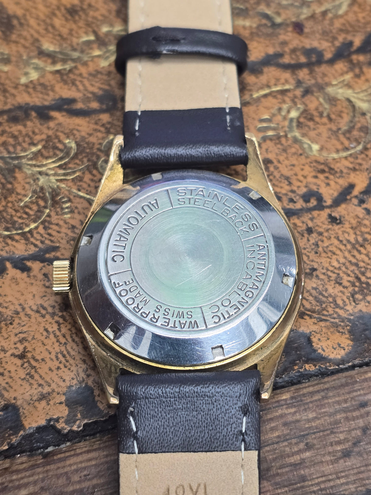 Vintage Ramona 30 Jewels Incabloc Swiss Made automatic watch by Reeves and Sons, showing the classic dial and stainless steel case.