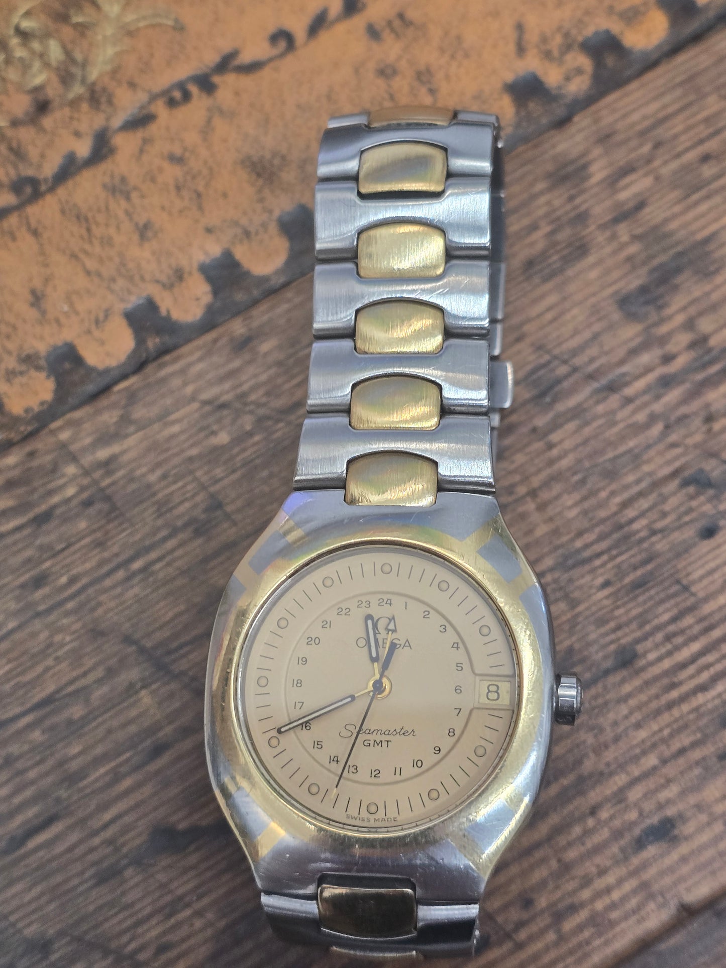 Omega Seamaster Polaris Chronograph vintage 1980s quartz watch with steel and gold bracelet, showcasing classic design and chronograph features.