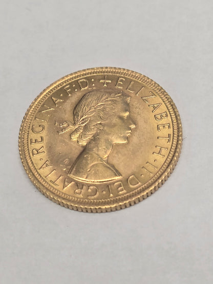 1966 Reeves and Sons gold sovereign coin in good condition, showcasing detailed design and gold surface.
