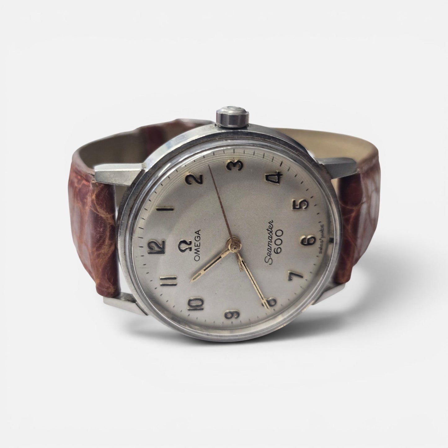 Vintage Omega Seamaster 600 Swiss watch with brown leather strap, featuring a classic round dial and stainless steel case.