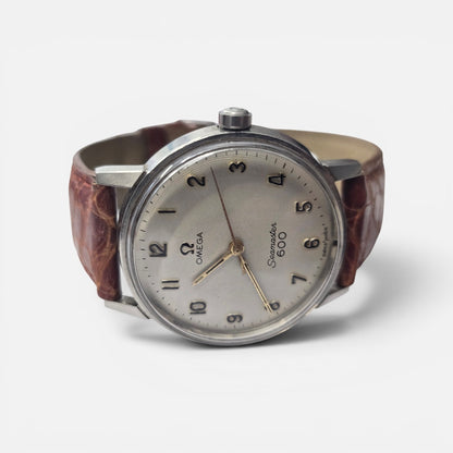 Vintage Omega Seamaster 600 Swiss watch with brown leather strap, featuring a classic round dial and stainless steel case.