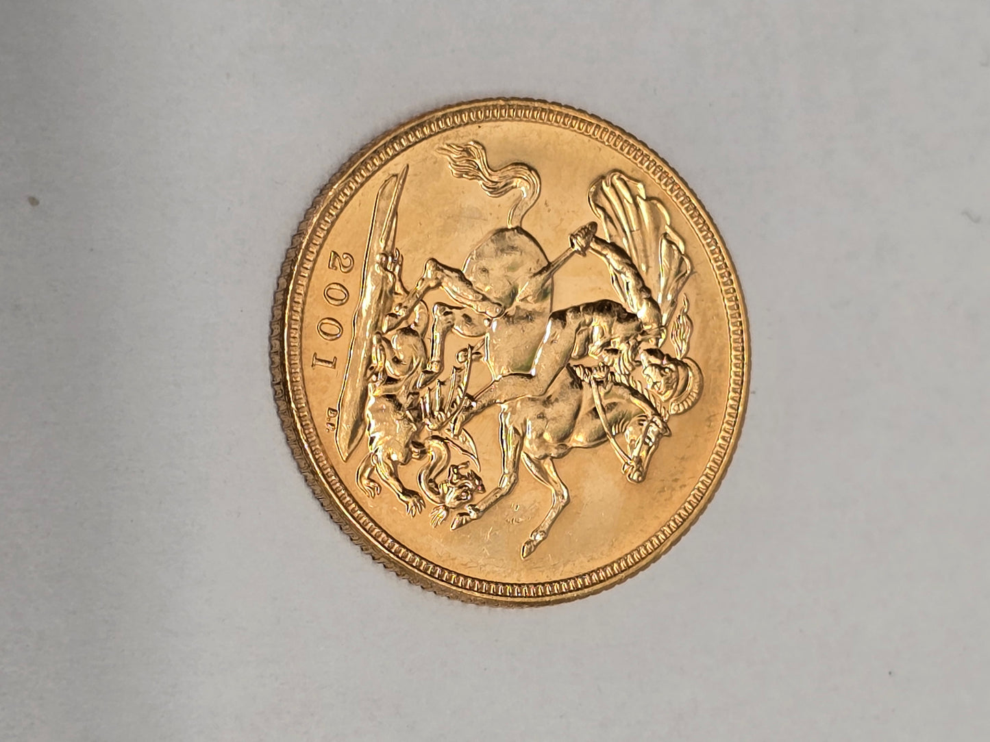 2001 Reeves and Sons full sovereign coin with detailed portrait and inscriptions, showcasing its classic gold design.