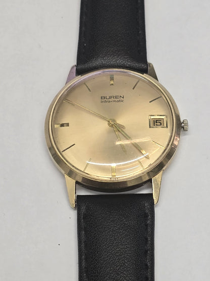 Vintage 9ct yellow gold Buren Intra-Matic automatic men's watch with Swiss craftsmanship, classic design, and leather strap.
