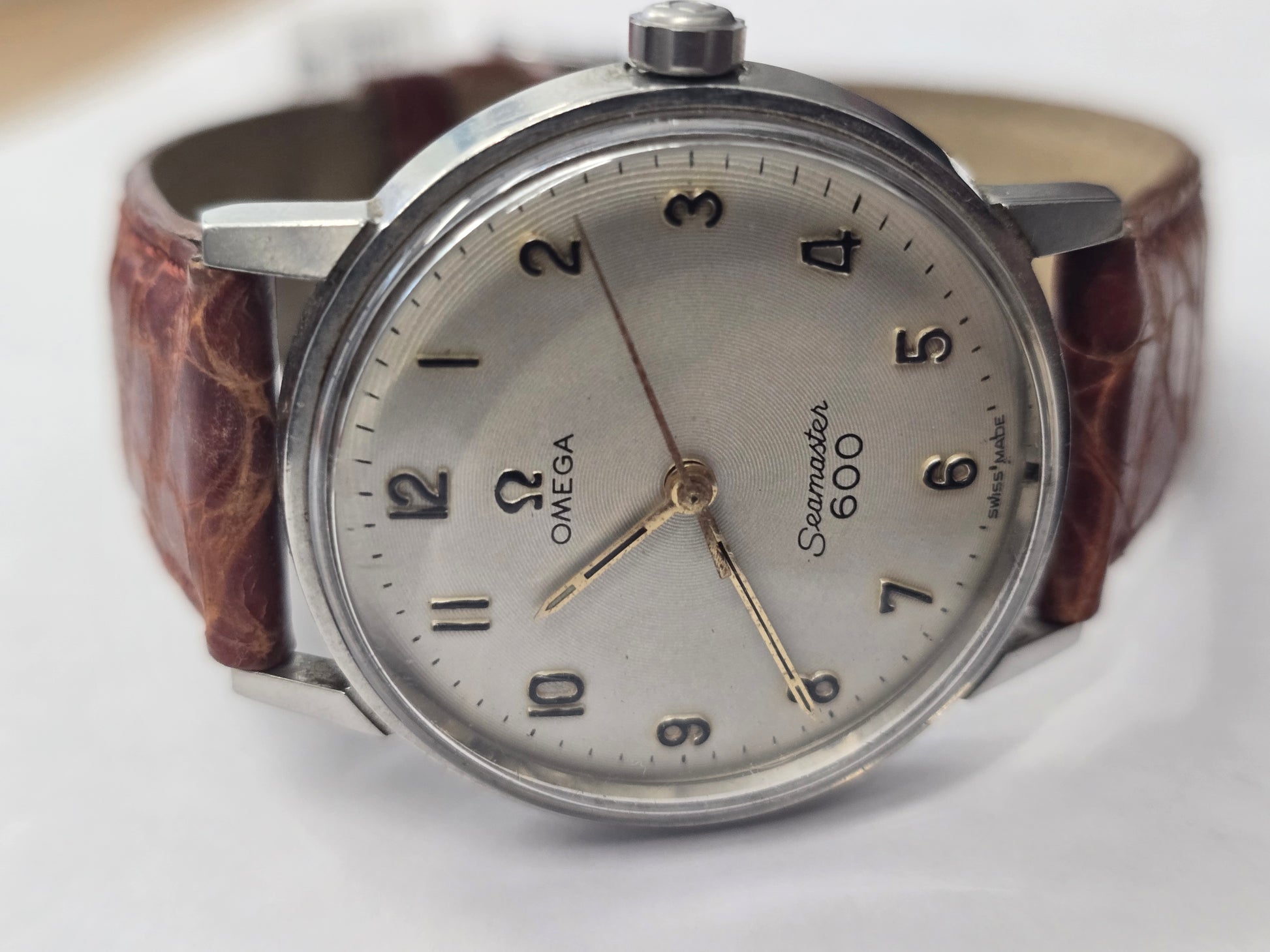 Vintage Omega Seamaster 600 Swiss watch with brown leather strap, showcasing classic dial and stainless steel case.